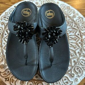 Fitflop is size 9 black Pom Pom beads ontop of sandal